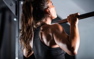 Woman athlete doing pull ups